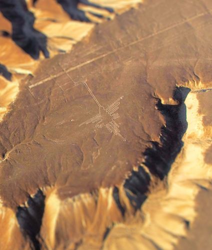 Flight over the Hummingbird figure at the Nazca desert.