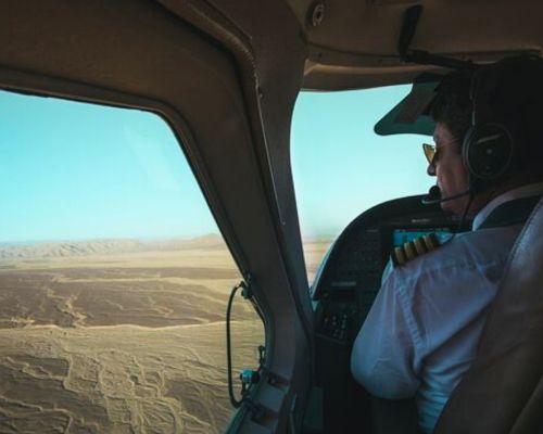 Pilot navigating a Nazca Lines overflight with desert geoglyphs visible below