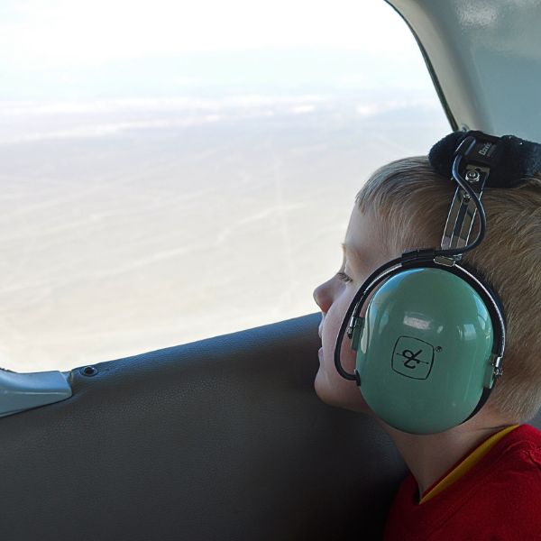 Young traveler gazing out from a scenic flight over the Nazca desert