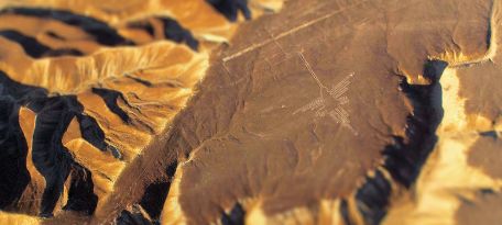 Aerial view of the Hummingbird geoglyph carved into the desert plateau of Nazca