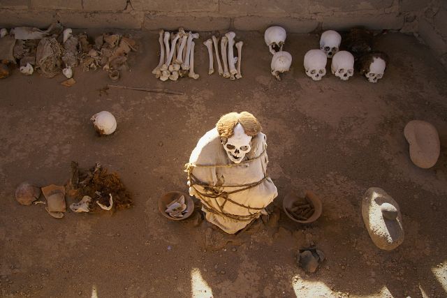 Ancient Nazca mummy and skulls at Chauchilla Cemetery archaeological site