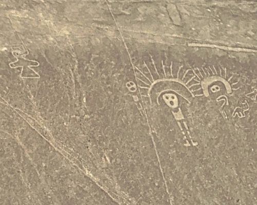 Mysterious ancient human-like petroglyphs carved into desert rock.