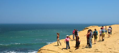 Travelers enjoying the stunning cliffs and ocean views in Paracas National Reserve.