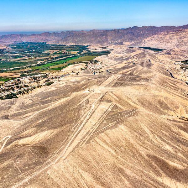 Aerial shot of large geoglyphs on desert hills near Palpa Valley during a Nazca Lines Private Flight