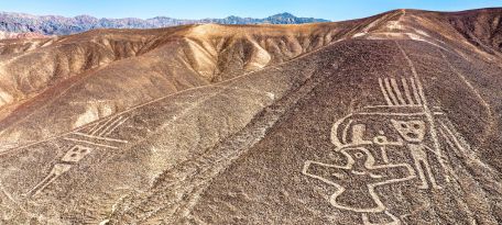 Aerial view of human-like geoglyphs etched on a hill slope in the Palpa Valley