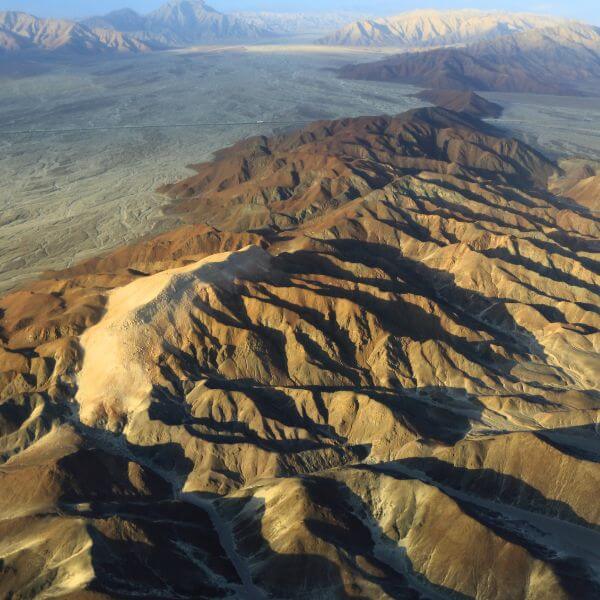 Aerial view of the Nazca desert mountain ridges seen during a Nazca Lines Private Flight