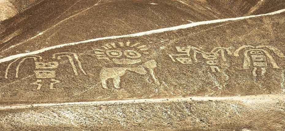 Aerial view of ancient human-like geoglyphs on a hillside in Palpa, Peru