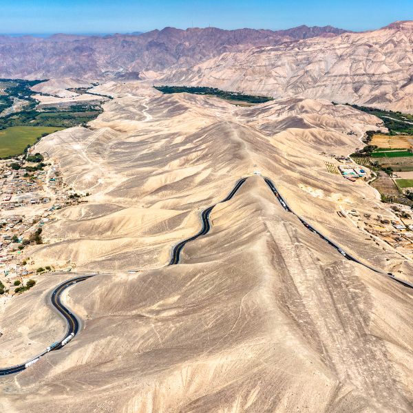 Winding road cutting through the desert hills of Palpa, Peru