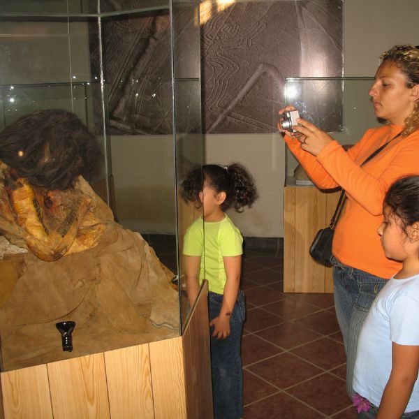 Visitors viewing a Paracas mummy inside the Maria Reiche Museum