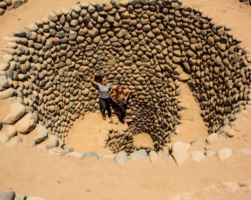 Visitors inside a spiral puquio.