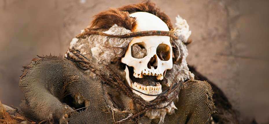 Mummy with preserved hair and burial clothing at Chauchilla Cemetery