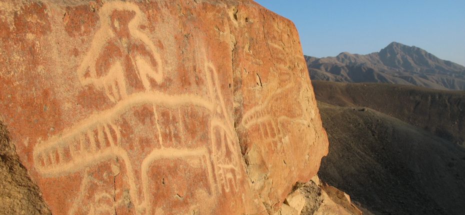 Ancient zoomorphic petroglyphs etched into red volcanic rock in Chichictara.