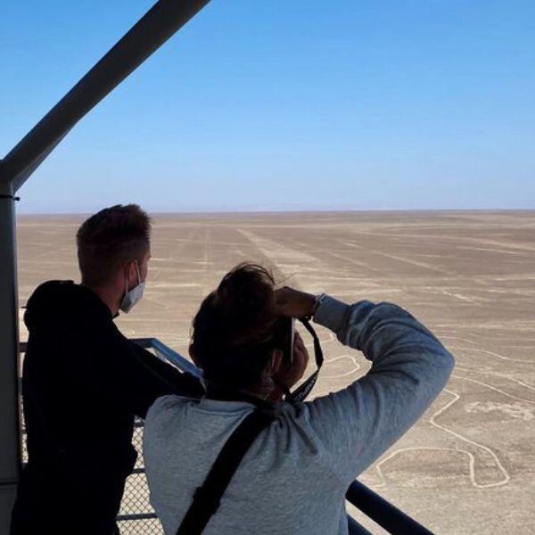 Tourists viewing Nazca geoglyphs from the tower