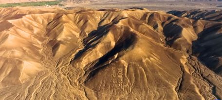 Aerial view of the Twins Geoglyphs carved on a desert hillside in Palpa, Peru.